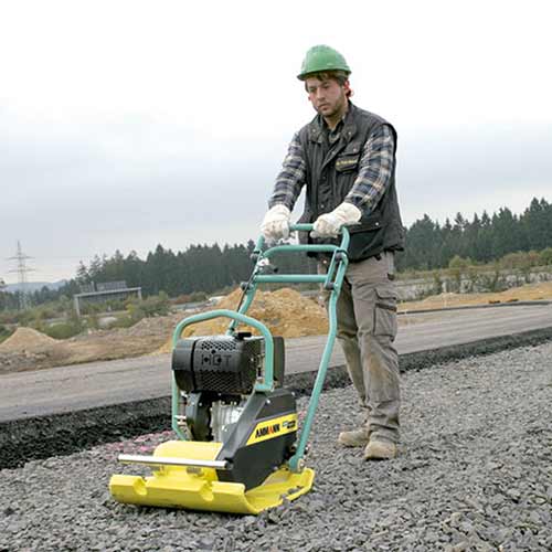 Picture showing an Ammann Forward Plate being operated on a tarmac road.